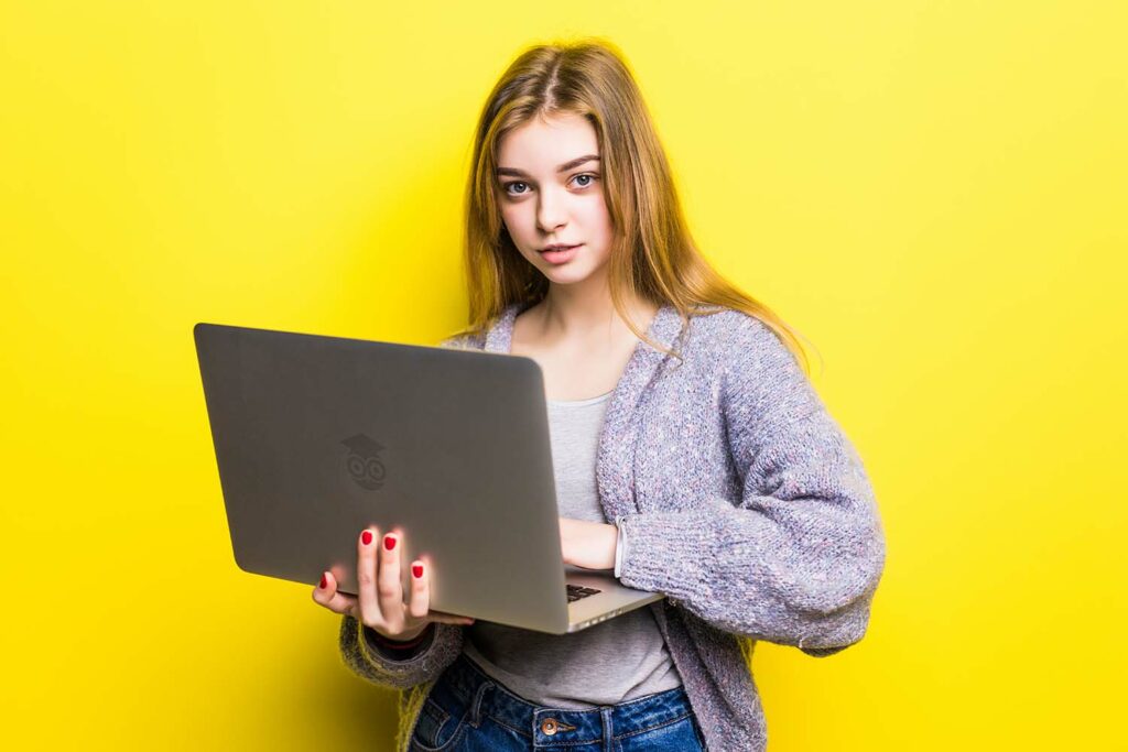 portrait smiling teenage girl holding laptop computer